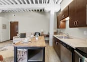 Thumbnail 10 of 55 - A kitchen with a table set for two and a dining area.