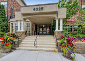 Thumbnail 43 of 49 - the front of a building with stairs and a entrance with flowers