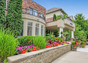 Thumbnail 21 of 49 - a house with flowers and plants in front of it