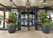Thumbnail 53 of 53 - an entrance to a building with two large planters in front of the door