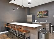 Thumbnail 29 of 53 - a kitchen with a long counter and chairs