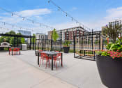 Thumbnail 41 of 53 - an outdoor patio with tables and chairs and a fire pit