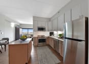 Thumbnail 8 of 53 - a kitchen with white cabinets and stainless steel appliances