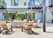 Thumbnail 11 of 71 - Two chairs and a table are on a patio.