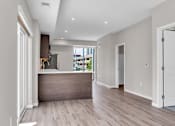 Thumbnail 71 of 71 - A spacious room with a reception desk and a door leading to another room.