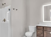 Thumbnail 64 of 71 - A white toilet sits next to a sink in a bathroom.