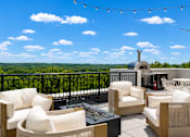 Thumbnail 25 of 88 - A patio with white furniture and a view of the sky.