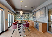 Thumbnail 18 of 71 - A modern kitchen with a dining table and chairs.