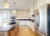 Thumbnail 38 of 65 - a large kitchen with stainless steel appliances and white cabinets at Ardor on the Bluffs South Loop Residences Apartments, Bloomington, Minnesota