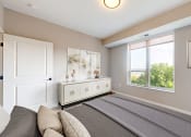 Thumbnail 4 of 65 - a bedroom with a large bed and a window at Ardor on the Bluffs South Loop Residences Apartments, Bloomington, Minnesota