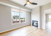 Thumbnail 47 of 65 - a living room with wood floors and a fireplace     and a window at Ardor on the Bluffs South Loop Residences Apartments, Bloomington, MN