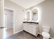 Thumbnail 50 of 65 - a white bathroom with a toilet and a sink at Ardor on the Bluffs South Loop Residences Apartments, Bloomington