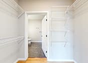 Thumbnail 49 of 65 - a walk in closet with two white closets and a toilet at Ardor on the Bluffs South Loop Residences Apartments, Minnesota, 55425