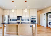 Thumbnail 45 of 65 - a kitchen with white cabinets and a counter top with a sink at Ardor on the Bluffs South Loop Residences Apartments, Minnesota