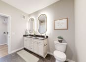 Thumbnail 7 of 65 - a bathroom with a toilet and a sink at Ardor on the Bluffs South Loop Residences Apartments, Bloomington, Minnesota