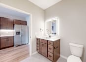 Thumbnail 58 of 65 - a bathroom with a toilet and a sink and a mirror at Ardor on the Bluffs South Loop Residences Apartments, Bloomington, 55425