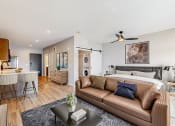 Thumbnail 17 of 65 - a living room with a couch and a bed at Ardor on the Bluffs South Loop Residences Apartments, Bloomington, MN