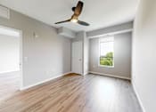 Thumbnail 63 of 65 - an empty living room with wood floors and a ceiling fan at Ardor on the Bluffs South Loop Residences Apartments, Minnesota, 55425