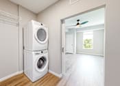 Thumbnail 65 of 65 - a white washer and dryer in a room with a door to a closet at Ardor on the Bluffs South Loop Residences Apartments, Bloomington, 55425