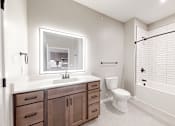 Thumbnail 19 of 65 - a bathroom with a sink toilet and a shower at Ardor on the Bluffs South Loop Residences Apartments, Minnesota