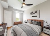 Thumbnail 9 of 65 - bedroom with a bed and a ceiling fan at Ardor on the Bluffs South Loop Residences Apartments, Bloomington, MN, 55425