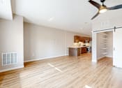 Thumbnail 25 of 76 - A room with a ceiling fan and a wooden floor.