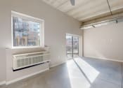 Thumbnail 24 of 65 - an empty living room with a large window and concrete floors at Ardor on the Bluffs South Loop Residences Apartments, Bloomington, 55425