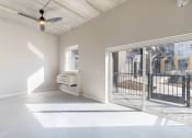 Thumbnail 23 of 65 - A spacious room with a ceiling fan and sliding glass doors. at Ardor on the Bluffs South Loop Residences Apartments, Bloomington, Minnessota
