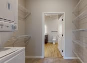 Thumbnail 35 of 65 - A white kitchen with a doorway leading to a bathroom at Ardor on the Bluffs South Loop Residences Apartments, Bloomington, MN, 55425