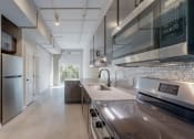 Thumbnail 29 of 65 - a kitchen with stainless steel appliances and a stainless steel counter top at Ardor on the Bluffs South Loop Residences Apartments, Bloomington