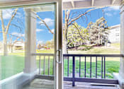 Thumbnail 23 of 83 - A view from a house looking out to a tree and a building.