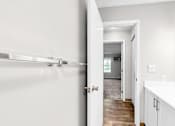 Thumbnail 21 of 83 - A white bathroom with a towel rack and a mirror.