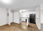 Thumbnail 13 of 83 - A kitchen area with a black fridge and white cabinets.