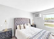 Thumbnail 11 of 83 - A bedroom with a large bed and a window overlooking a street.
