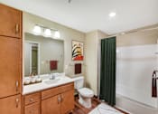 Thumbnail 6 of 32 - A bathroom with a toilet, sink, and shower.