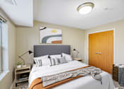 Thumbnail 8 of 32 - A bedroom with a large bed and a painting on the wall.