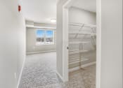 Thumbnail 13 of 32 - A white room with a window and a white closet.