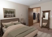 Thumbnail 16 of 34 - a bedroom with a bed and a mirror  at Briarcliff Apartments, a 55+ Community, Mahtomedi, MN
