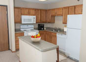 Thumbnail 14 of 34 - a kitchen with a white refrigerator freezer next to a white stove top oven  at Briarcliff Apartments, a 55+ Community, Mahtomedi, Minnesota
