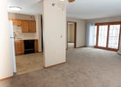 Thumbnail 12 of 34 - an open living room with a kitchen in the background  at Briarcliff Apartments, a 55+ Community, Minnesota