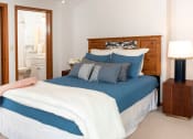 Thumbnail 6 of 34 - a bedroom with a bed and a nightstand  at Briarcliff Apartments, a 55+ Community, Mahtomedi, Minnesota
