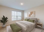 Thumbnail 110 of 113 - A bedroom with a large bed, a green bench, and a potted plant.