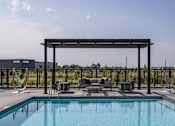 Thumbnail 55 of 61 - A pool with a hammock and a canopy.