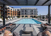 Thumbnail 53 of 61 - A pool surrounded by lounge chairs and umbrellas.