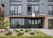 Thumbnail 46 of 61 - A building with a sign that says "COPPER" on it.