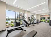 Thumbnail 20 of 61 - A gym with treadmills, elliptical machines, and other equipment.