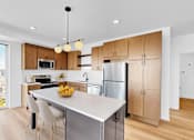 Thumbnail 32 of 61 - A modern kitchen with a view of the city.