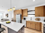 Thumbnail 39 of 61 - A modern kitchen with wooden cabinets and a white island.