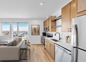 Thumbnail 43 of 61 - A modern kitchen with a view of the city through the windows.