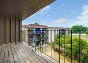 Thumbnail 25 of 56 - a balcony with a wooden floor and a metal railing